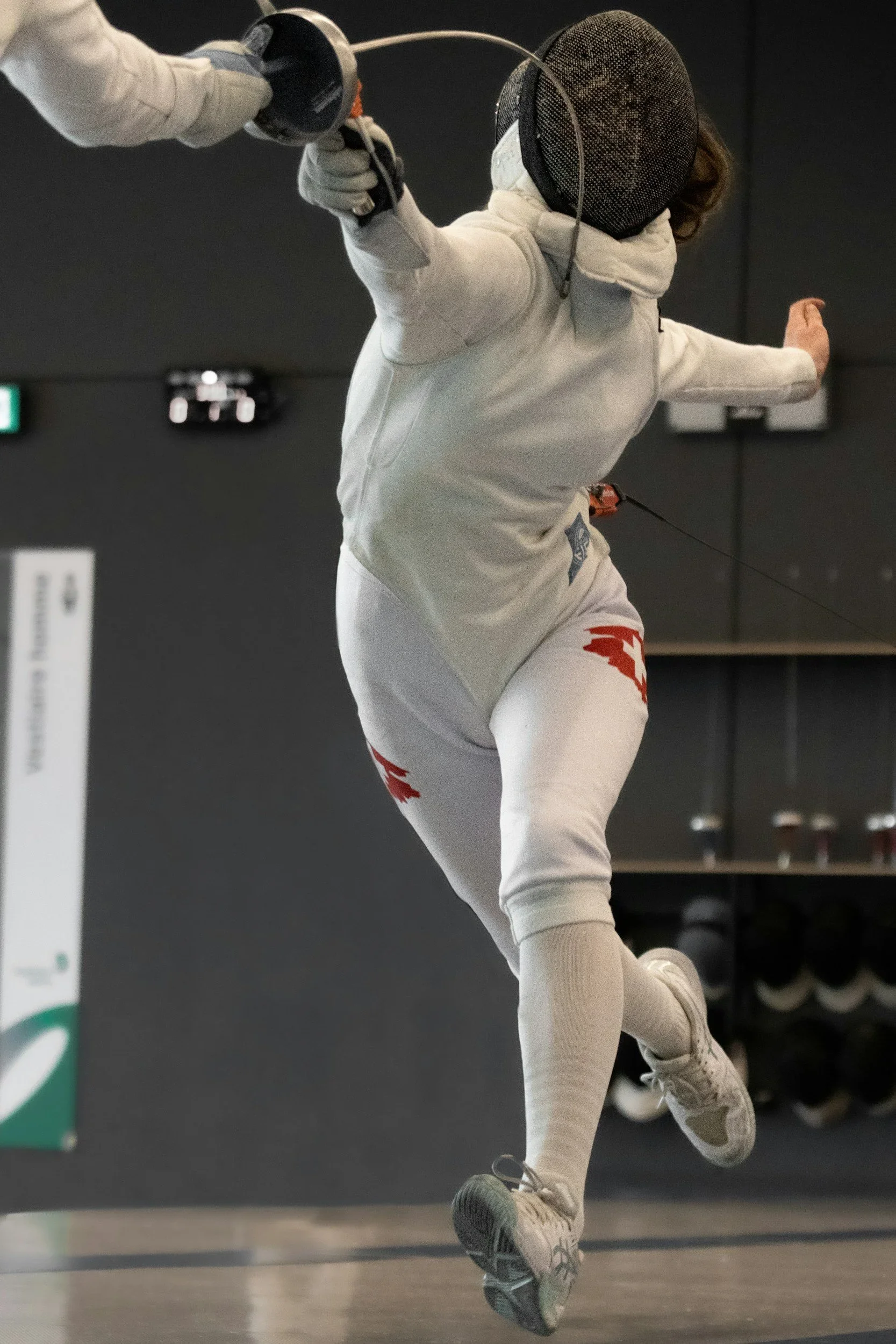 A fencer mid-lunge during a competitive bout